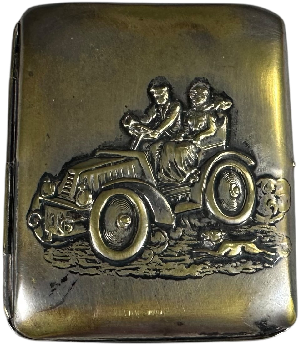 EMBOSSED AUTOMOTIVE THEME CIGARETTE CASE: 192. EMBOSSED AUTOMOTIVE THEME CIGARETTE CASE | From the David Bausch Automobilia collection. | 3.5" l. | (Very Good Condition) | $300 - $600