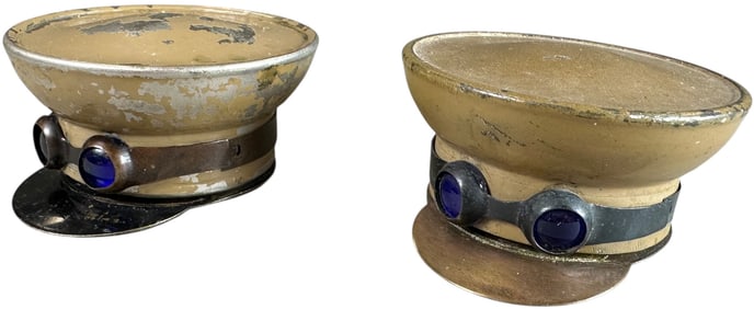 TWO HAND PAINTED TIN CHAUFFER CAP INKWELLS