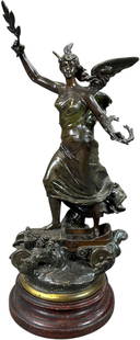 ERNEST JUSTIN FERRAND SCULPTURE ON WOOD BASE: 253. ERNEST JUSTIN FERRAND SCULPTURE ON WOOD BASE | C. 1910, spelter with bronze patina sculpture of winged female triumphantly standing atop an automobile holding a laurel branch, titled "The Triumph
