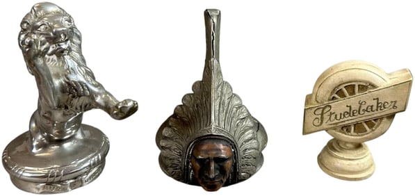 THREE DECORATIVE RADIATOR ORNAMENTS AND CAPS