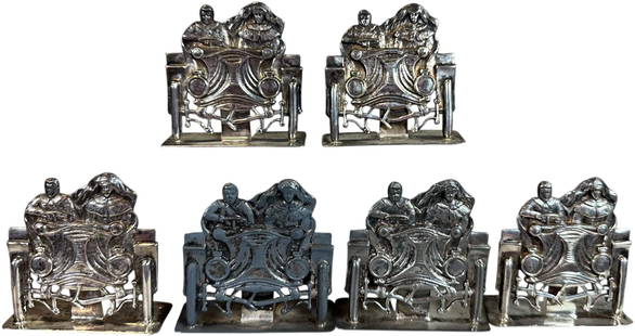 SIX SILVER PLATED AUTOMOTIVE PLACE CARD HOLDERS: 330. SIX SILVER PLATED AUTOMOTIVE PLACE CARD HOLDERS | From the David Bausch Automobilia collection. | 2.5" l. | (Very Good to Excellent Condition) | $400 - $800