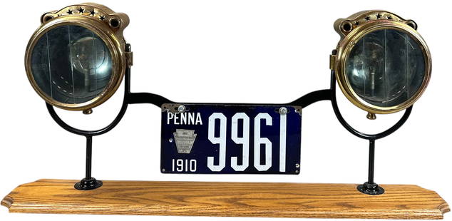PA 1910 LICENSE PLATE & HEADLAMPS DISPLAY: 346. PA 1910 LICENSE PLATE & HEADLAMPS DISPLAY | From the David Bausch Automobilia collection. | 36.5" h. | (Excellent Condition) | $150 - $300