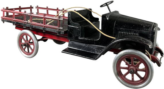 BUDDY L STAKE BED TRUCK - SPOKE WHEELS: 421. BUDDY L STAKE BED TRUCK - SPOKE WHEELS | Scarce spoked wheel version. | 24.5" l. | Original stake sides, one repainted wheel, some black touch-up to paint chips in areas, (Very Good Condition) |