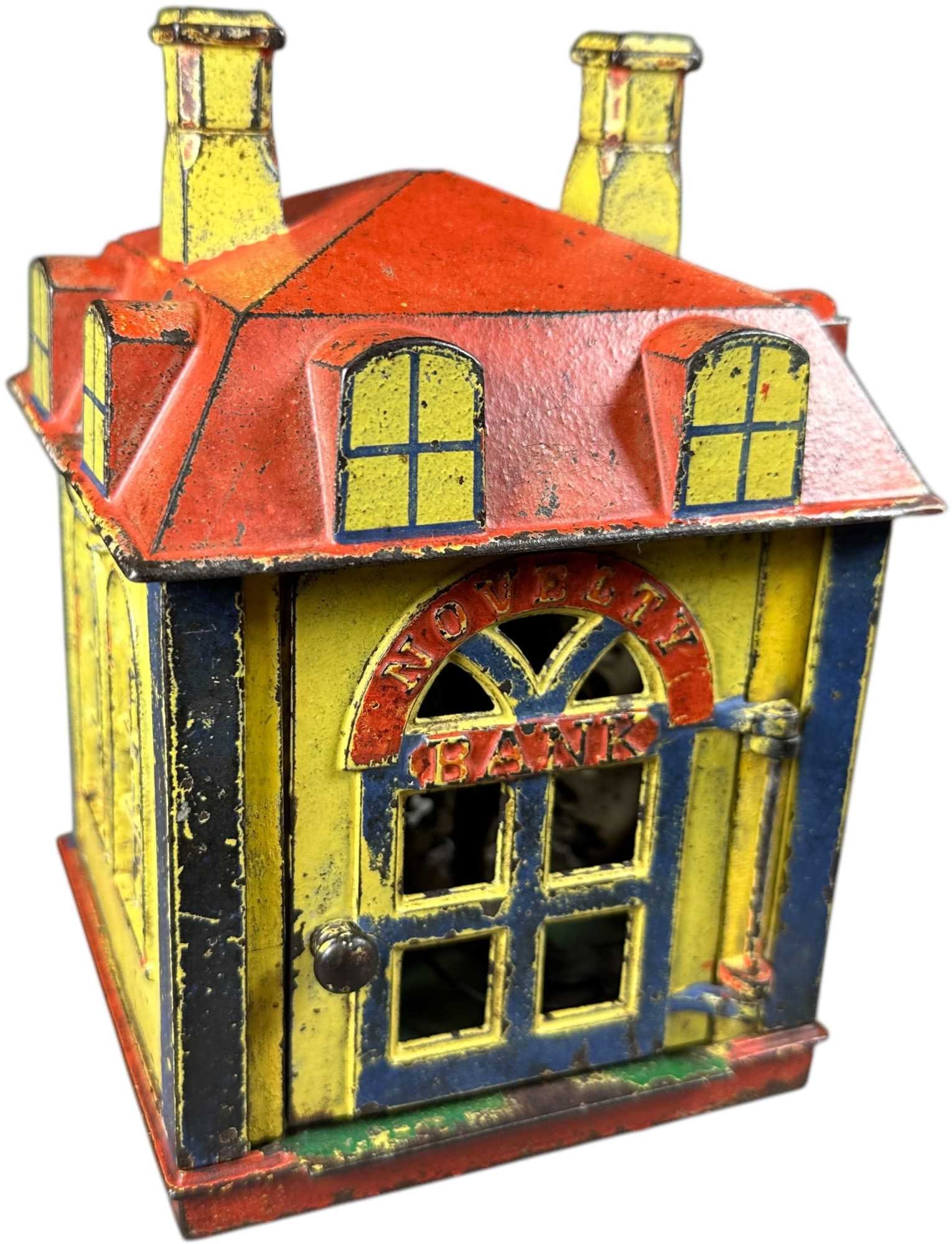 NOVELTY BANK MECHANICAL BANK: 180. NOVELTY BANK MECHANICAL BANK | J&E Stevens Co. | 7" h. | Recast figure, front door frame has crack repairs, (Very Good Condition) | $300 - $600