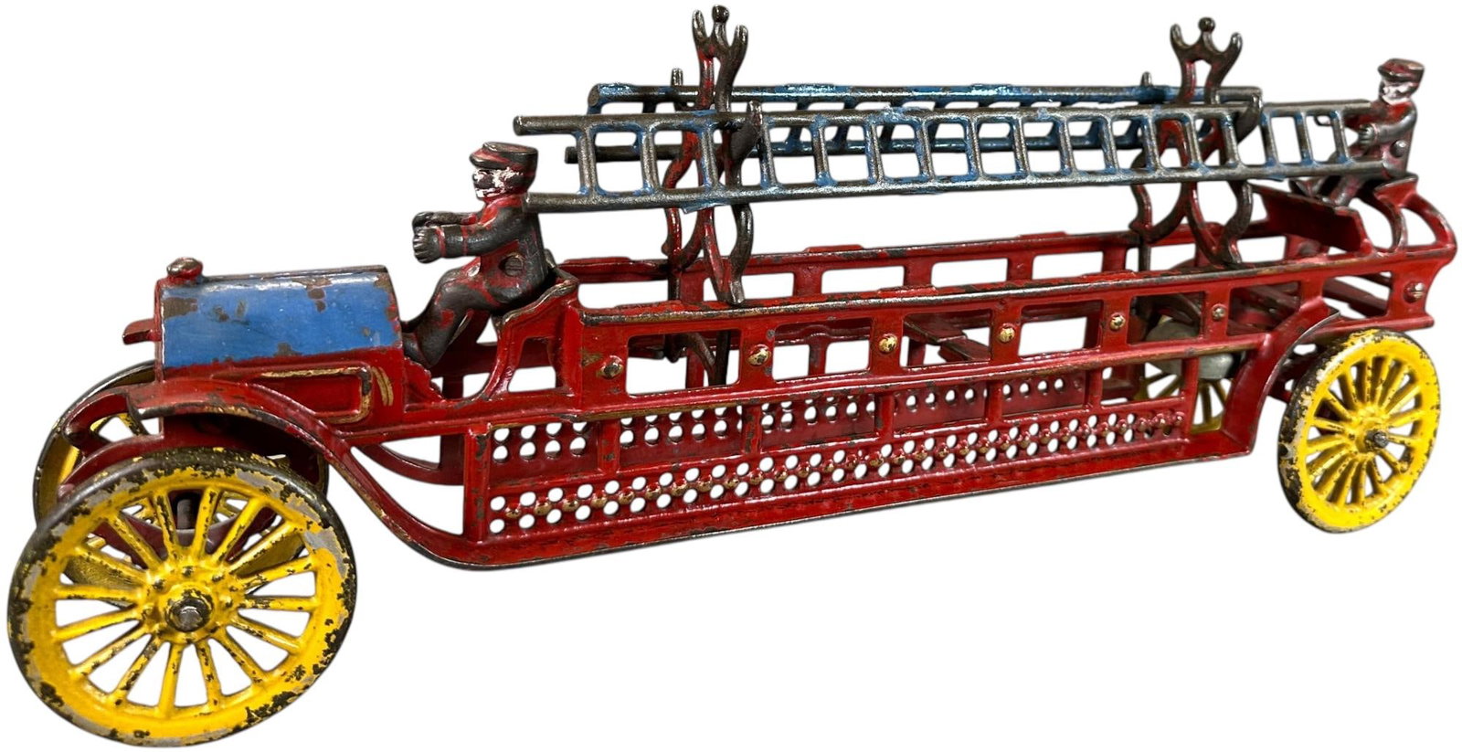MULTICOLOR DENT LADDER TRUCK: 421. MULTICOLOR DENT LADDER TRUCK | Scarce transitional series toy with great paint colors. | 18" l. | All original including figures and ladders, (Excellent Condition) for this scarcer toy. | $600 - 