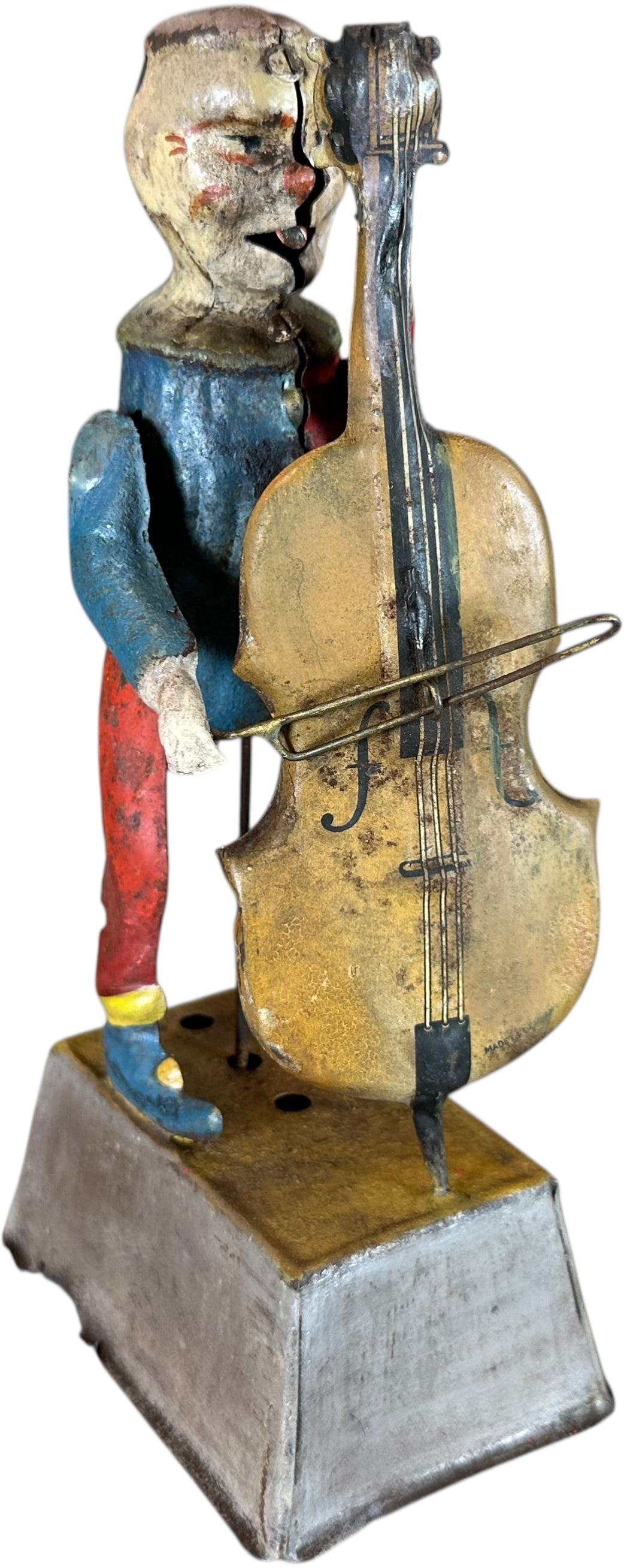 GUNTHERMANN CLOWN PLAYING CELLO: 502. GUNTHERMANN CLOWN PLAYING CELLO | From the Italian collection of Steno Tonelli. | 8.5" h. | Some repaint in areas, toy could brighten with a cleaning, (Very Good Condition) | $400 - $800