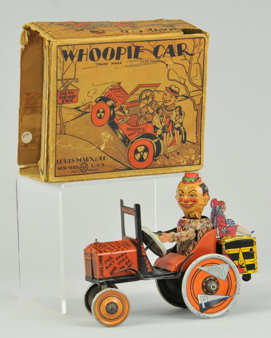 WHOOPIE CAR WITH BOX: Louis Marx Toys, lithographed tin, original seated girls on rear trunk, one of the more whimsical in series, toy suitcase on side of hood, key wind operated. 8" l.
