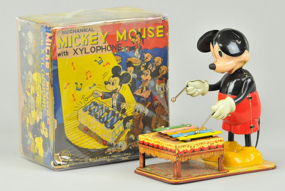MICKEY PLAYING XYLOPHONE WITH BOX: Marx toy, features figure of Mickey w/sticks in hand playing xylophone attached to tin litho base. 6 1/2" h.