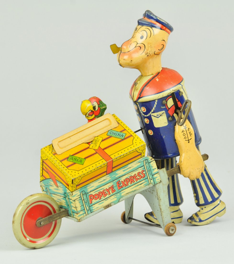 POPEYE EXPRESS: Lithographed tin and clockwork driven, amusing toy depicts Popeye pushing wheelbarrow cage with parrot peering through top, able to conceal body in trunk when activated. 8 1/4" h.