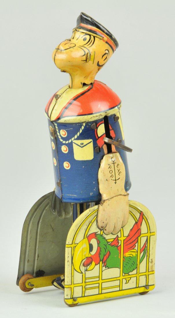 POPEYE CARRYING PARROT CAGES: Lithographed tin, depiction of Popeye walking with two parrots in cages, clockwork mechanism activates walking motion. 8 1/2" h.