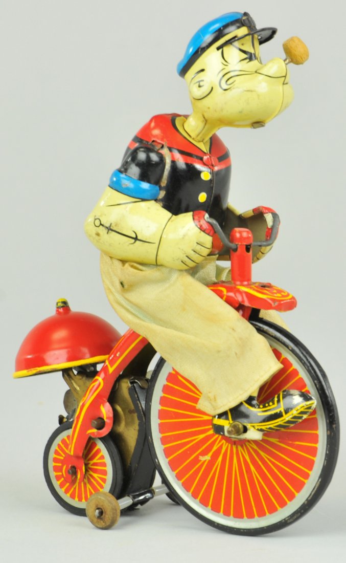 POPEYE ON TRICYCLE: Linemar, Japan, tin depiction of Popeye on tricycle with cloth pants, bright color graphics with bell on the back. 5" x 7".
