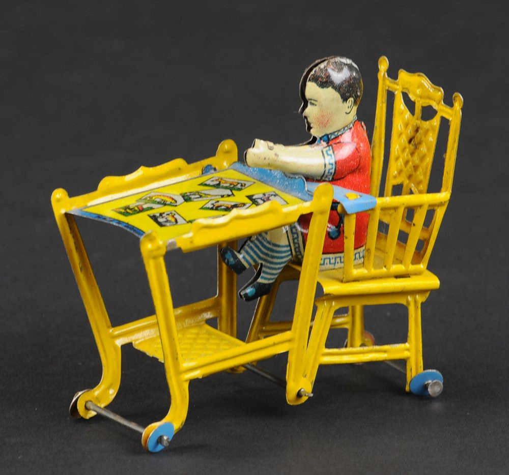 BABY'S CHAIR PENNY TOY: Meier, Germany, lithographed tin, child sits in highchair that converts to table, animal graphics on table top. 2 3/4" l.