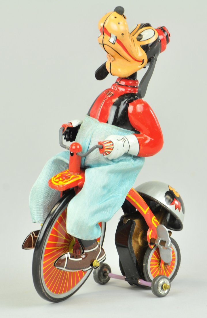 GOOFY CYCLIST: Linemar Toys, Japan, lithographed tin toy depicts Goofy the dog w/cloth pants riding old time bicycle, clockwork driven action includes ringing of bell. 7 1/2" h.