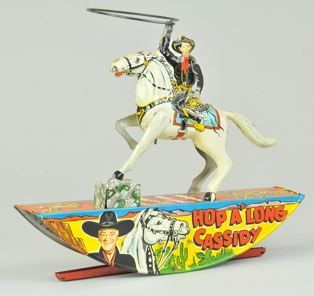 HOP A'LONG CASSIDY ON HORSE: Marx, rocking toy done in lithographed tin, depicts famous cowboy star with lasso in hand riding horse, key wind operated. 11 1/4" l.
