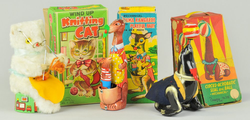 LOT OF THREE BOXED WIND-UP ANIMAL TOYS: Japan, amusing grouping includes: Mama Kangaroo with Playful Baby in her pouch, Knitting Cat seated on stool, and Circus Acrobatic Seal with Ball on nose, nice actions. Approx. 6" h. x 2 1/2" w.