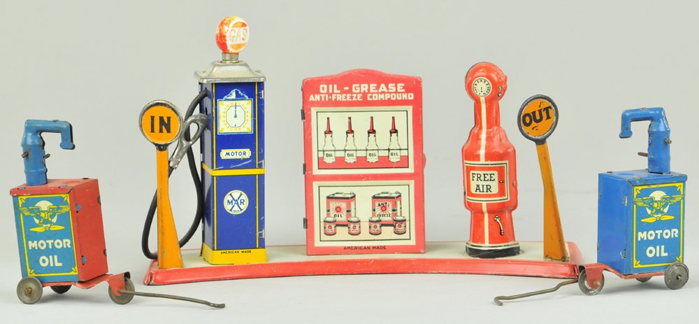 LOT OF TIN SERVICE STATION TOYS: Marx, lithographed tin fuel pump station with corner signs, together with two portable oil fill bins on wheels. 9 1/2" w.