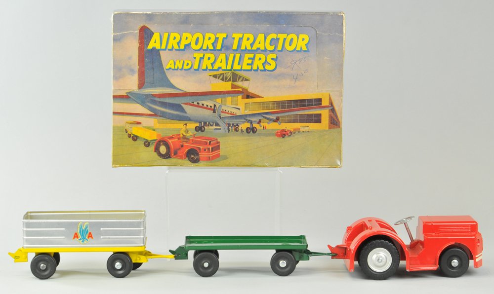 DOEPKE MODEL TOYS AIRPORT TRACTOR & TRAILERS SET: In original box, very colorful examples, make this three-piece set, includes red tractor, yellow aluminum cart, and green flat trailer, rubber tires, nice box graphics. Tractor 8" l., 9" x 14".