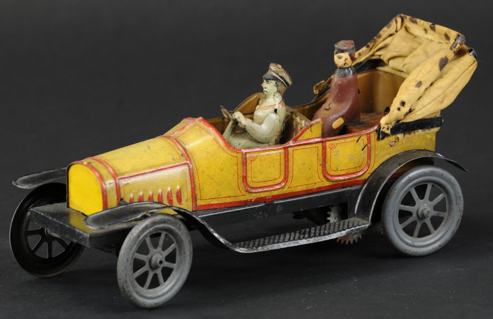 FISCHER TOURER: Germany, lithographed tin, open tourer with cloth canopy for rear passenger, yellow body, red striping, embossed seating, spoke wheels, contains driver and passenger. 8 1/2" l.