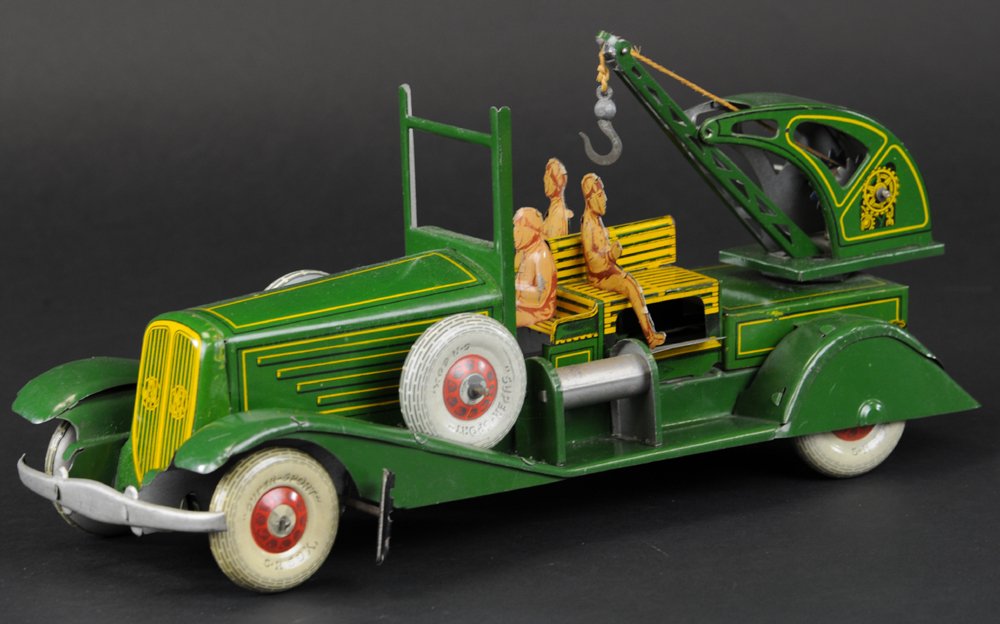 CHARLES ROSIGNOL AUTO WRECKER: France, c. 1935, a very large service truck with rear mounted wrecking boom on swivel base, features three seated figures on open bench seating, spare wheels on fenders, done in green body, yellow hig