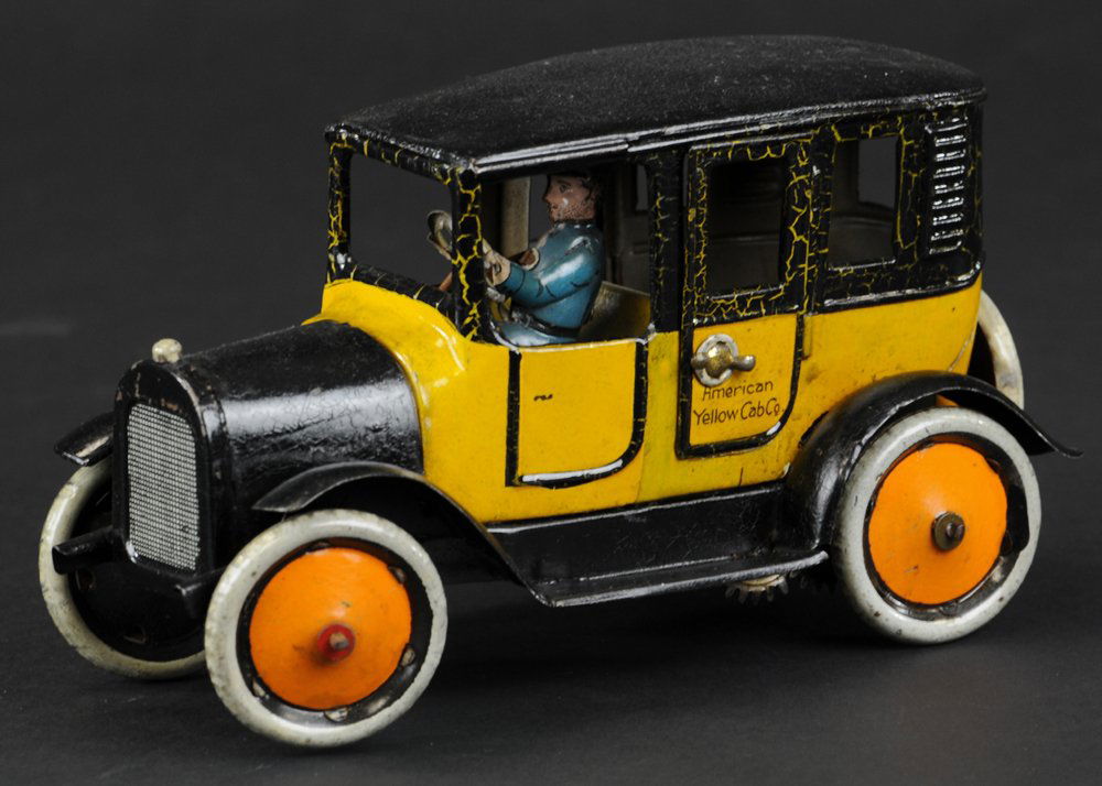 BING YELLOW TAXI: Germany, classic yellow and black body, reads "American Yellow Taxi" on opening door, orange disc wheels, seated driver, key wind driven, spare on rear. 8 1/2" l.