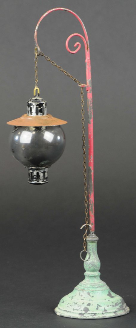 BING RAILROAD STREET LAMP: Germany, bright pink pole, ornate wire support for spirit lamp, heavy die-cast base painted in green. 14" h.