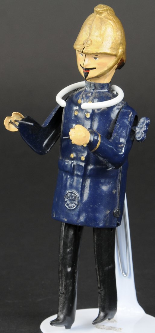 FIREMAN FIGURE: Martin, France, painted tin figure, clockwork, missing folding ladder for figure to climb. 8" h.