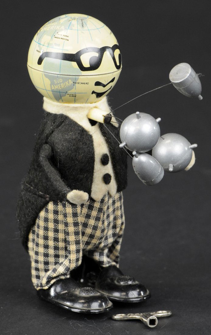SCHUCO MISTER ATOM: Germany, c. 1960, lithographed tin, globe shaped head, felt suit, holds simulated atoms in hands, clockwork action allows spinning of atoms, quite amusing piece, includes a partial box, not for this.