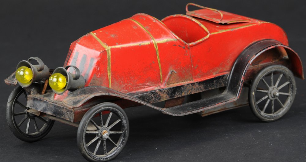 FRENCH TORPEDO WITH RUMBLE SEAT: France, attributed to Pinard, has distinctive electric head lamps and body work as made by the French toy maker, hand painted in red body overall, opening rumble seat with top rail, spoke wheels, cloc
