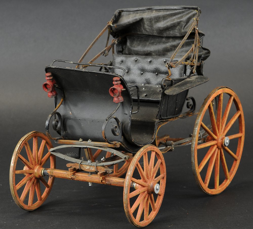 HORSELESS CARRIAGE: c. 1980, contemporary rendition of early travel, upholstered bench seating, fold-down top, spoke wheels, nice display piece for dollhouse entry. 12" l. x 9" h.