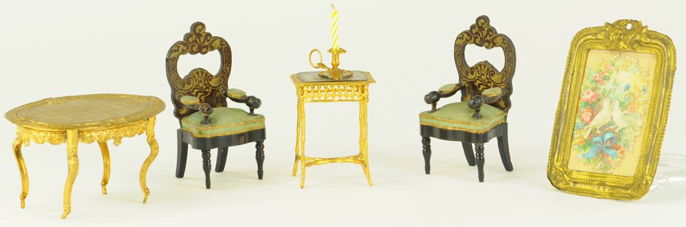 MINIATURE ORMOLU & BOULLE FURNITURE: Oval ormolu table with impressed designs, two Boulle armchairs with padded arms upholstered in green silk, a square ormolu table with metallic top mounted on rope-like legs, a large ormolu framed prin