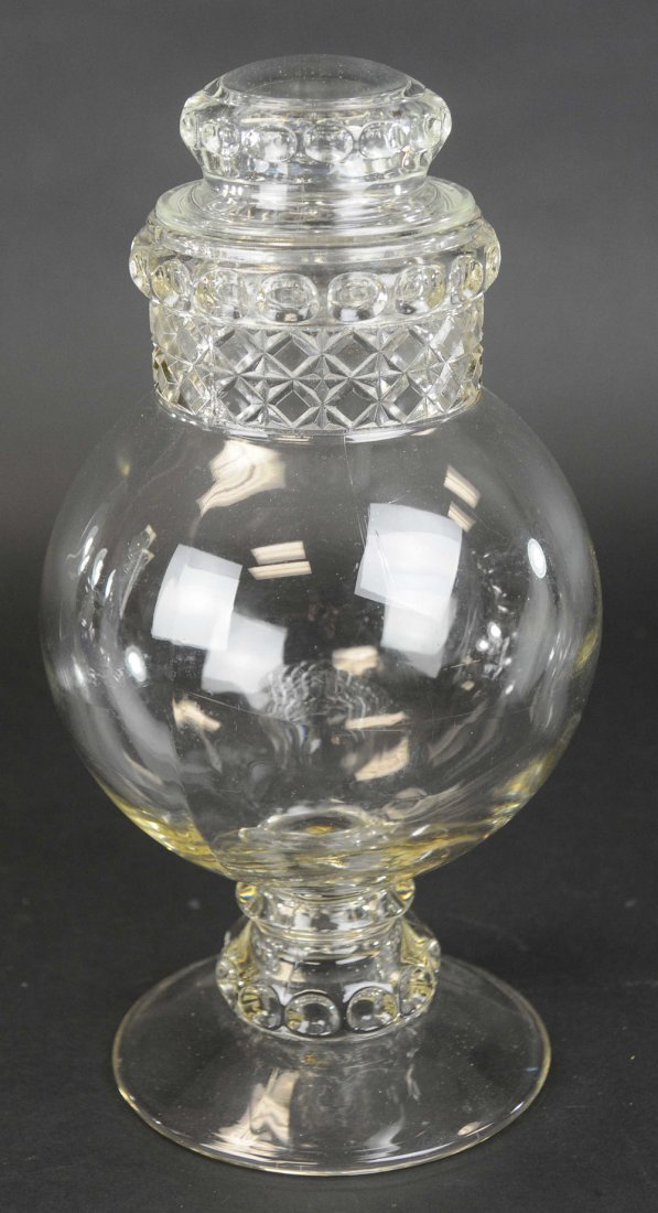 HANDS IN DAKOTA CANDY JAR: Dakota Globe, hands in country store candy show jar on pedestal. 15" h.