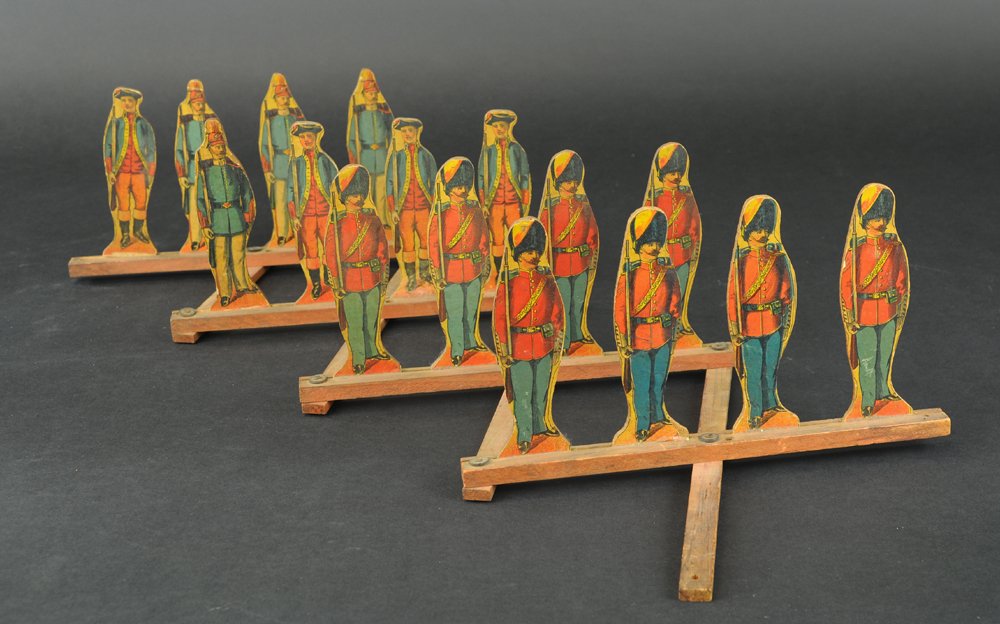 REED SOLDIER SCISSOR SET: Featuring sixteen lithographed paper on wood soldiers, each fits into slotted wooden base, scissors base unfolds to allow appearance of large army of soldiers. Extends to 60" l.