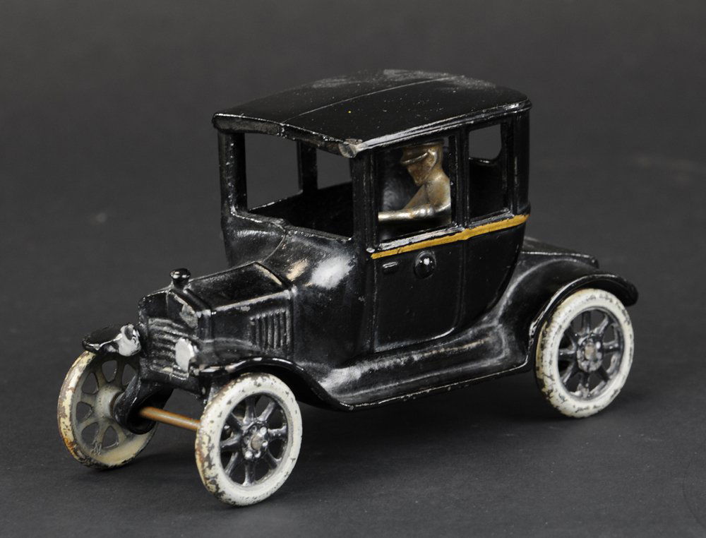 ARCADE FORD MODEL 'T' COUPE: Arcade, cast iron, painted in black overall, gold stripe on side, spoke wheels done in white. 6 1/2" l.
