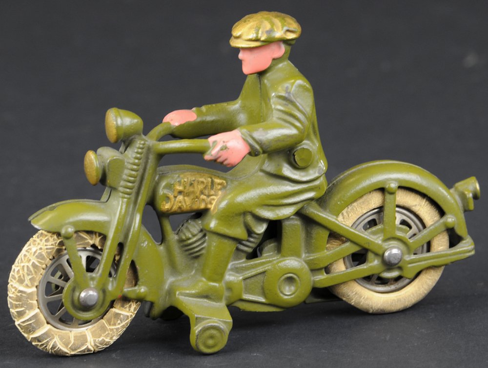 HUBLEY HARLEY DAVIDSON CIVILIAN RIDER: Cast iron, painted in olive green overall, embossed lettering on tank, rider depicted wearing cap, rubber tires, nickel spoke wheels. 6 1/2" l.