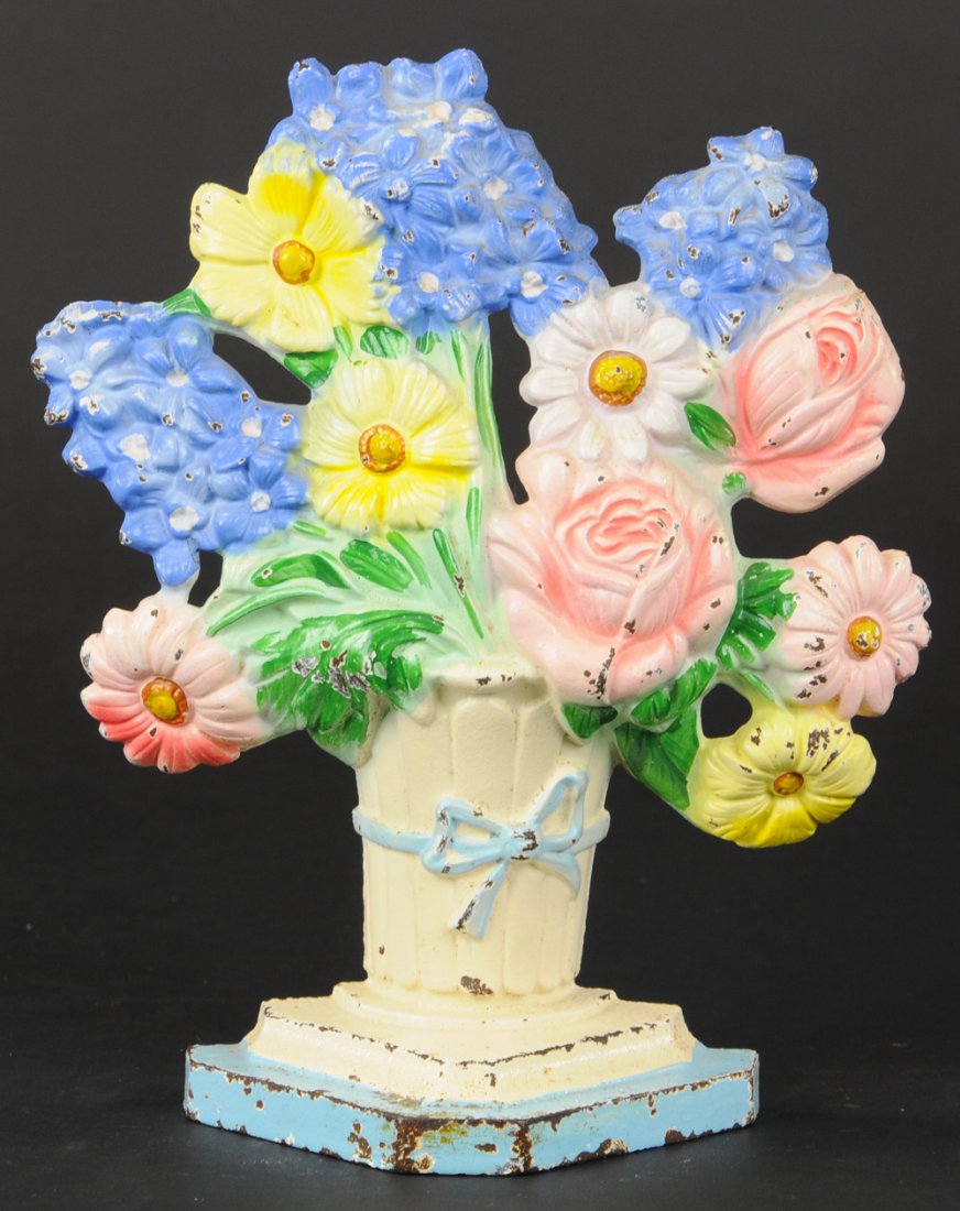 DELPHINIUM DOORSTOP: Hubley "490 Made in USA," multi-colored pastel floral arrangement with white vase & blue base, visually stunning colors and detail, delicate blue bow depicted on center of vase. 8 1/2" h.