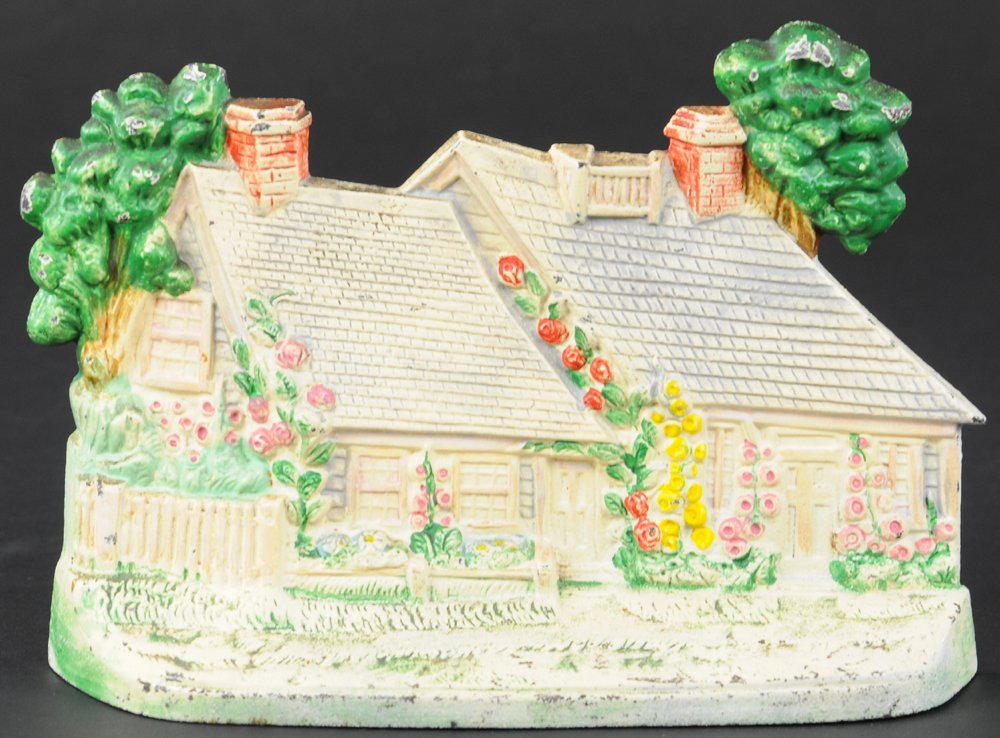 CAPE COD DOORSTOP: Hubley, very charming depiction of an ocean side Cape Cod home. 5 1/2" h.