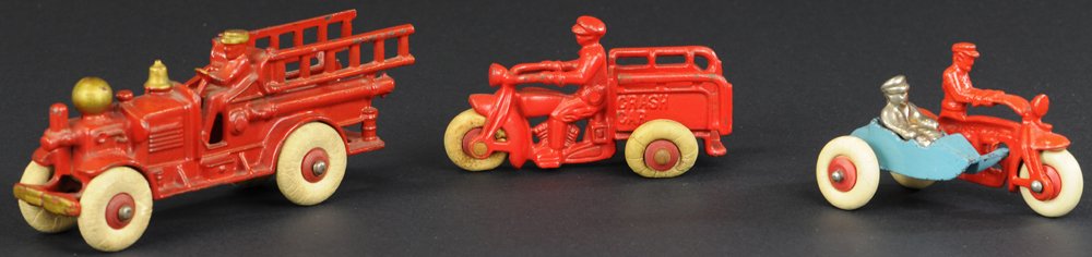 LOT OF THREE HUBLEY CAST IRON TOYS: Includes small Crash Car, "Cop" Cycle with sidecar in red and blue, and small Ahren's Fox Ladder Truck, all with rubber tires. 4" to 7" l.