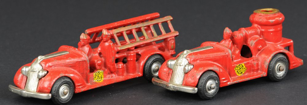 LOT OF TWO FIRE TRUCKS: Arcade, cast iron, painted in red, both feature nickel grilles, includes fire pumper and ladder truck, black rubber tires, decal on side. 6 3/4" l.