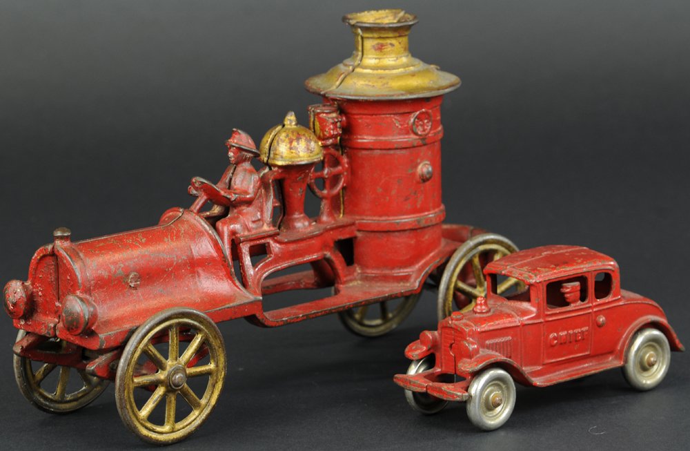 KENTON FIRE CHIEF AUTO & FIRE TRUCK: Cast iron, painted in red overall, embossed "Chief" on side of auto, well molded toys, pumper cast on bed with open platform, one nickel disc wheels, one spoke wheels. 5 1/2" to 6 3/4" l.