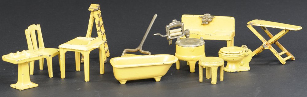 VARIED MINIATURE FURNITURE GROUPING: Cast iron, Kilgore appliances, together with kitchen and bath items, all painted in yellow. 2" to 4".
