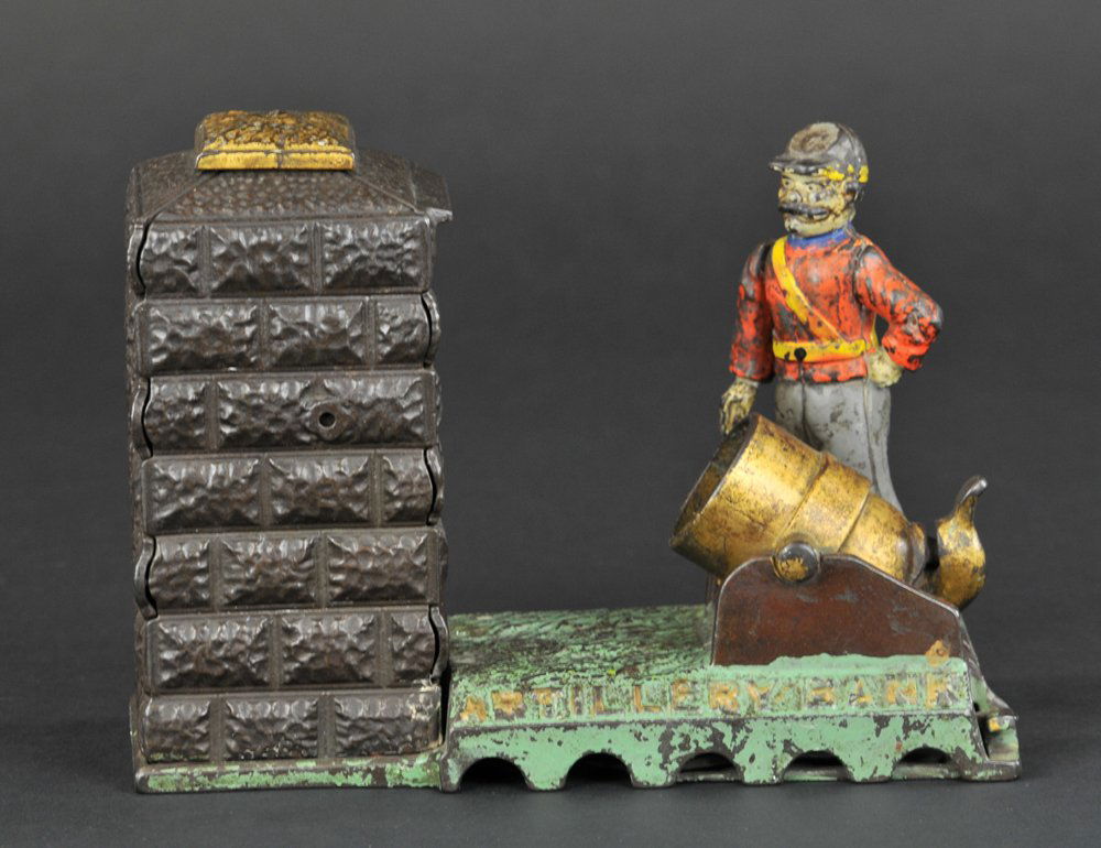 ARTILLERY CONFEDERATE (GREY PANTS) MECHANICAL BANK: Cast iron, J & E Stevens Co., designed by Charles G. Shepard & Peter Adams, Patent No. D-21,594 on 5/31/1892. The coin is placed in the cannon. The hammer is then pushed back; the right arm moves into