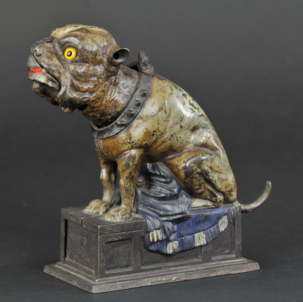 BULL DOG (BLUE BLANKET) MECHANICAL BANK: J & E Stevens Co., designed by James H. Bowen, patented 4/27/1880. Place the coin on the nose of the dog, and as the tail is pulled, he will throw the coin off, catch it in his mouth, and swallow it.