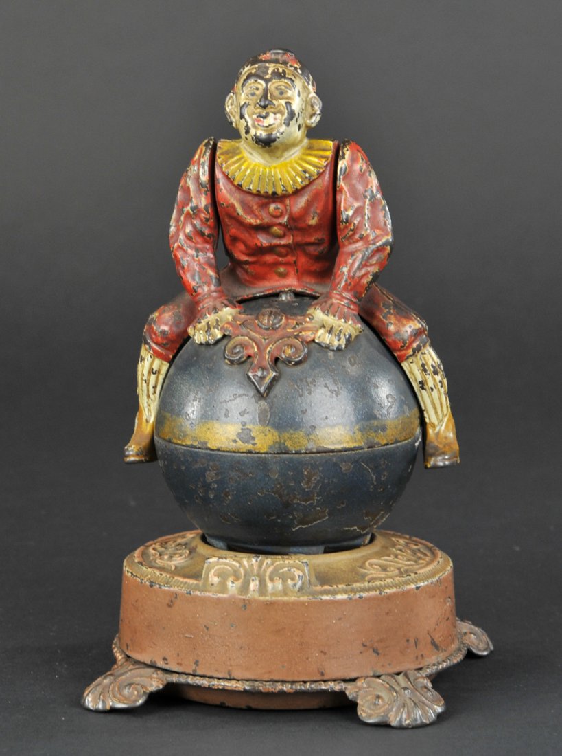 CLOWN ON GLOBE MECHANICAL BANK: J & E Stevens Co., designed by James H. Bowen, patented 5/20/1890. When the globe is brought into position, and the lever is released, the globe and clown whirl around in a very amusing manner. By pre