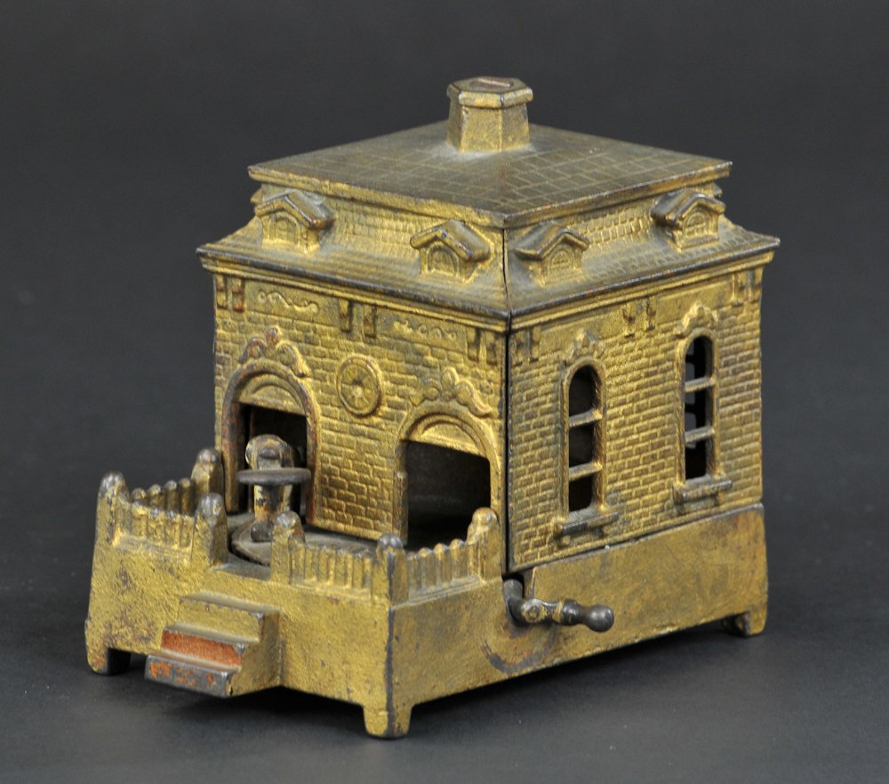 DOG ON TURNTABLE MECHANICAL BANK: Gold Base, Judd Mfg. Co., circa 1870's. By the handle, the dog goes in and deposits penny, coming out of the other door for more.