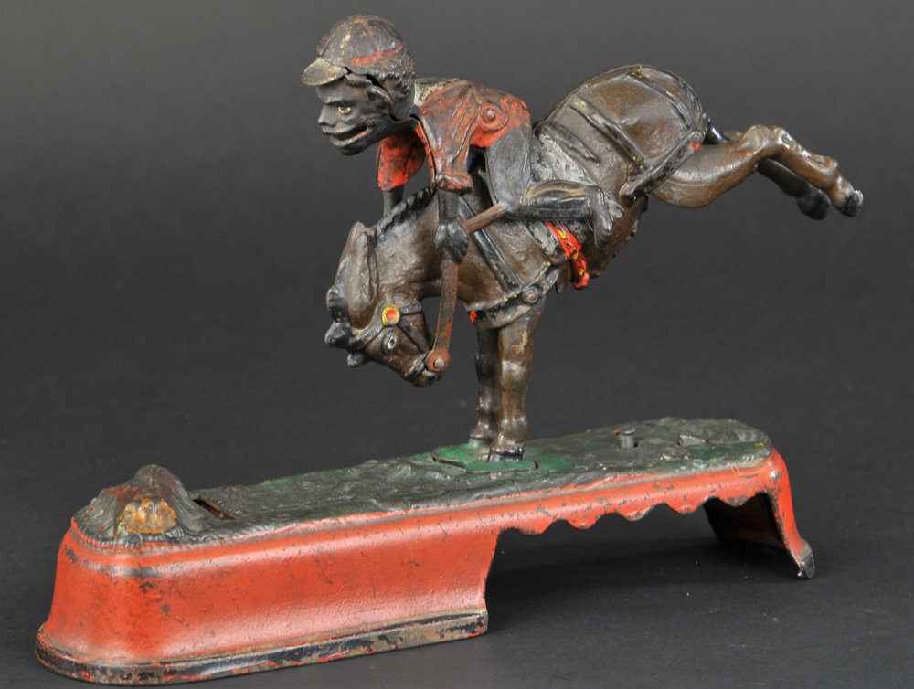 I SPISE A MULE (JOCKEY) MECHANICAL BANK: J & E Stevens Co., designed by James H. Bowen, patented 4/22/1879. The mule and rider being brought into position, a slight touch on a knob at the base causes the mule to kick and throw the rider over