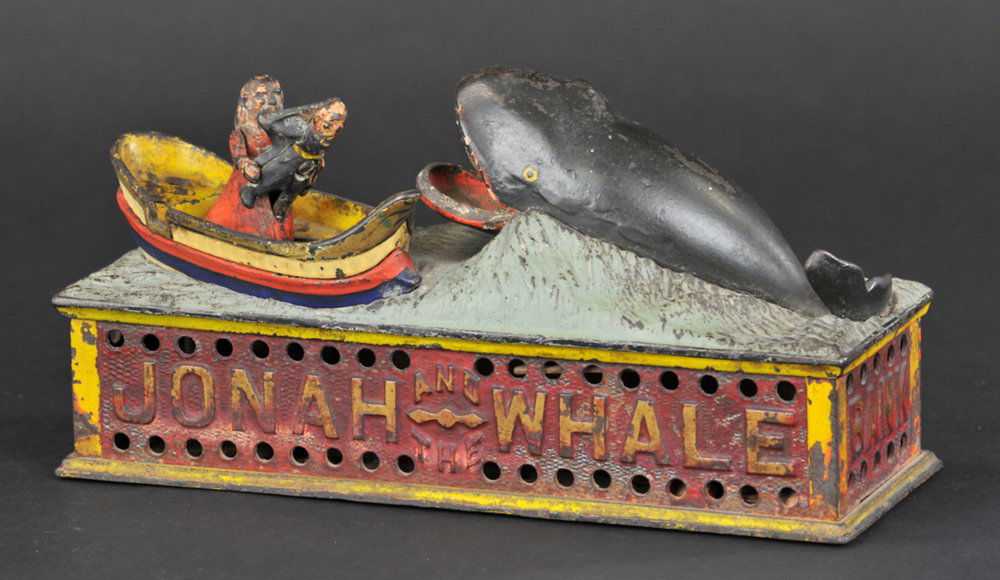 JONAH AND THE WHALE MECHANICAL BANK: Shepard Hardware Co., designed by Peter Adams, patented 7/15/1890. Place a coin on Jonah’s head and press the lever; the man tosses Jonah forward as if to throw him overboard and the whale opens his