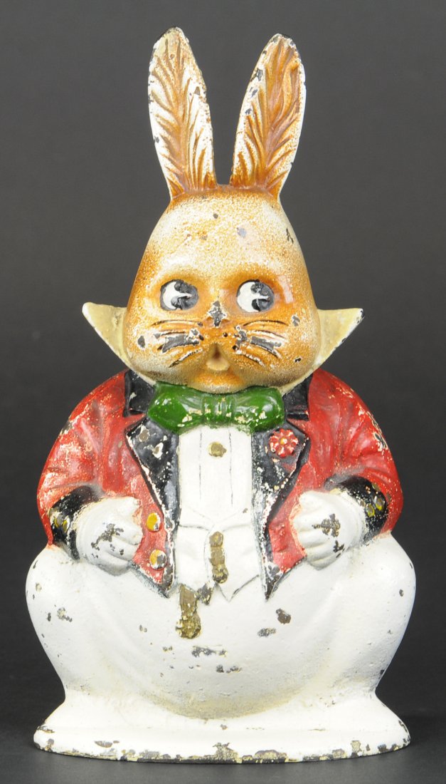 GRANDPA RABBIT DOORSTOP: Cast iron, depicts rotund bunny in formal wear, whimsical piece, very desirable & rare. BOOK EXAMPLE. 8 1/2" X 4 1/2".