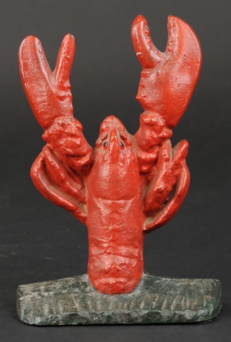 LOBSTER DOORSTOP: Interesting casting of lobster half emerged from base, colored red overall, great casting effects, very desirable. 8 1/2" h.
