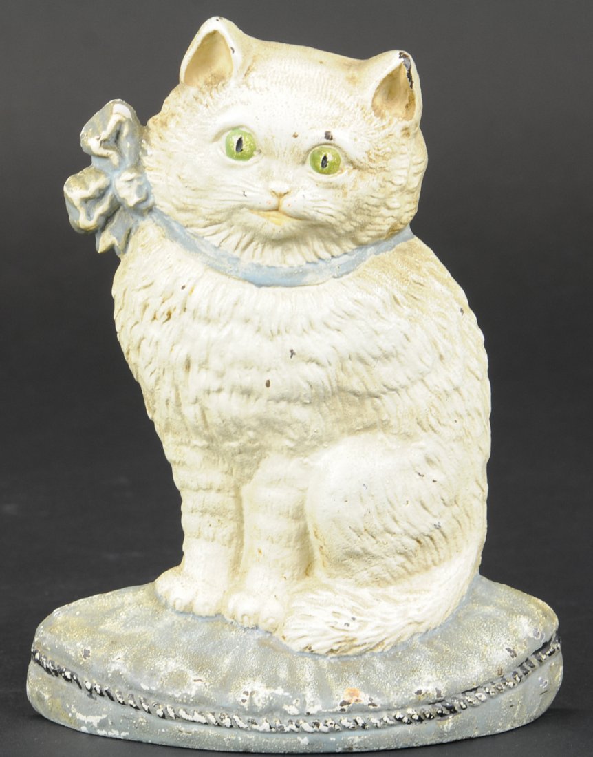 SITTING CAT DOORSTOP: Beautiful white cat sitting tall on blue-gray base, excellent casting details with green eyes & blue bow. 8" h.