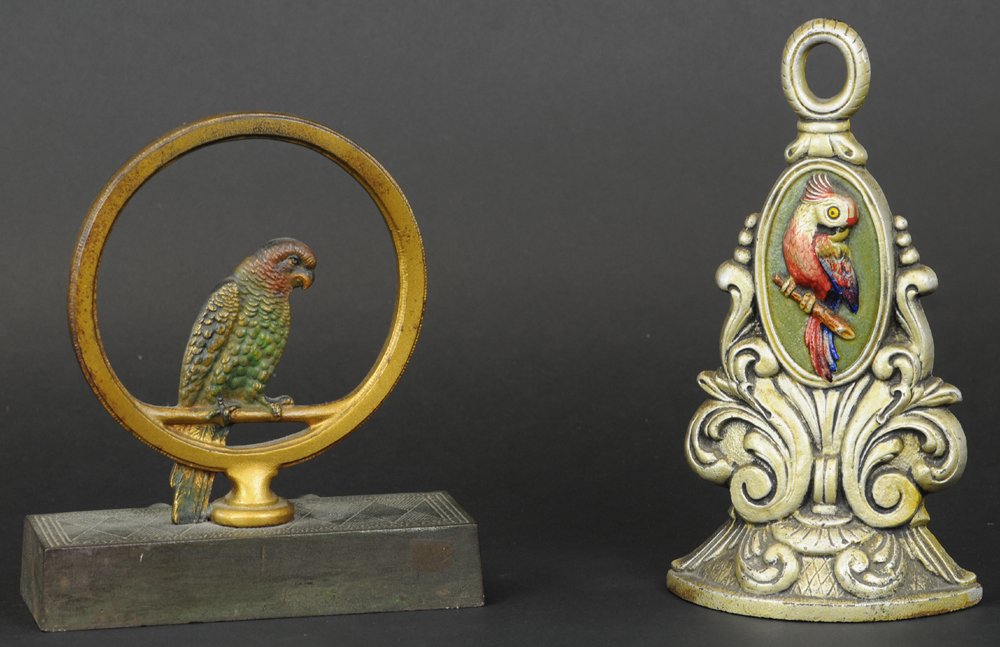 COCKATOO IN RING & PARROT IN MEDALLION DOORSTOP: B&H, multi-colored bird on gold painted ring with heavy rectangular base, rubber knobs intact, also includes ornately decorated medallion with parrot design. 8" - 9" h.